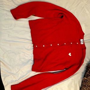 A red long sleeved sweatshirt Red with a white heart and bottoms down the middle